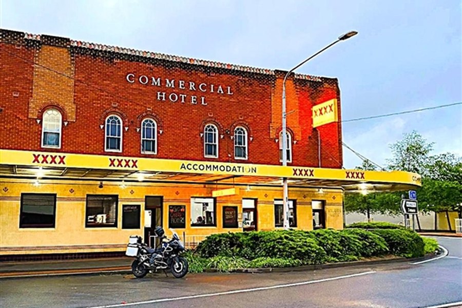 The Commercial Hotel's street frontage at dusk, with the accommodation awning lit